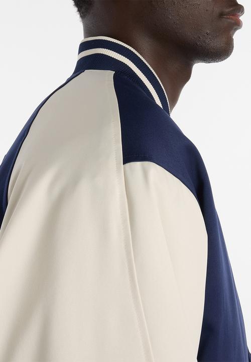 New Balance  - NB Athletics Varsity Jacket - Blue