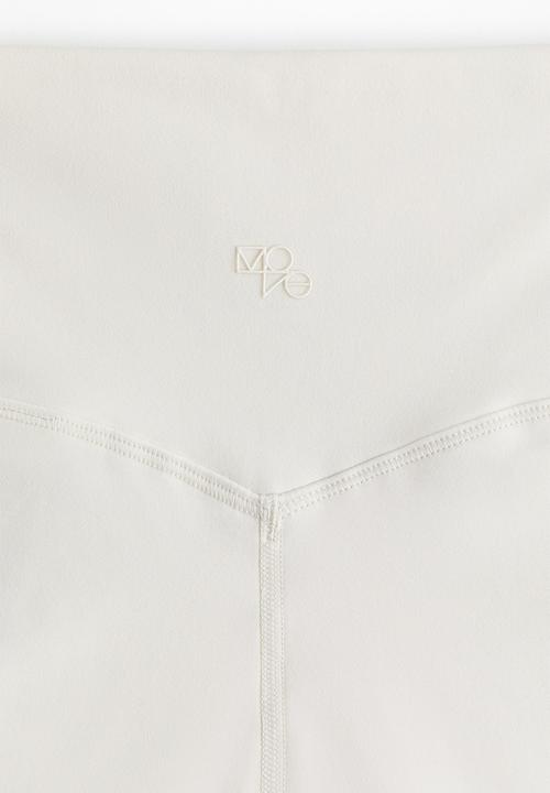 H&M - Sports leggings with softmove™ - cream