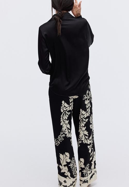 H&M - Wide trousers - black/patterned