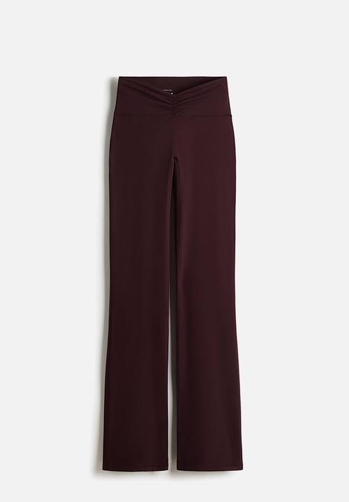 H&M - Flared yoga leggings with softmove? - chocolate plum purple
