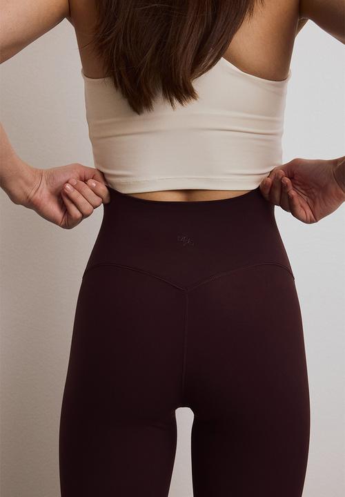 H&M - Flared yoga leggings with softmove? - chocolate plum purple