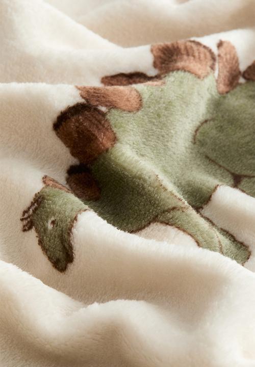 H&M - Patterned fleece blanket - light beige/dinosaurs