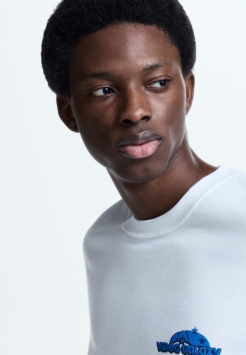 H&M - Loose fit printed T-shirt - white/video galaxy