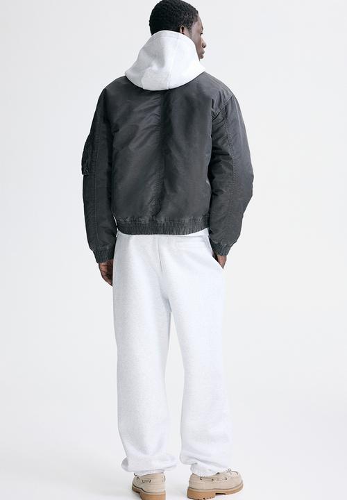 H&M - Loose fit sweatpants - light grey marl/fortes fortuna