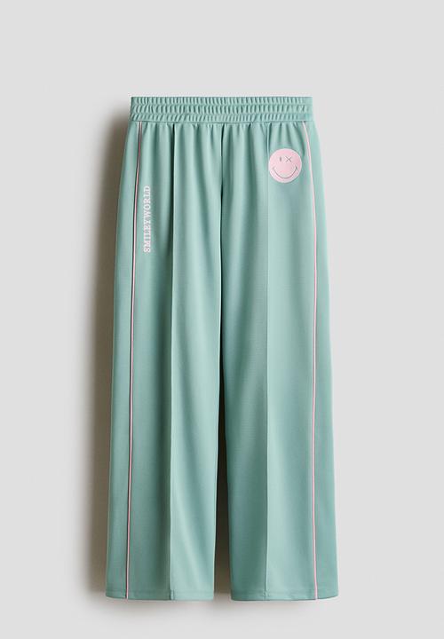 H&M - Wide-leg track pants - light green/smileyworld?