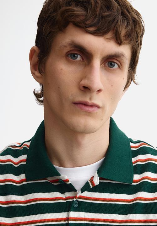 H&M - Slim fit polo shirt - dark green/striped