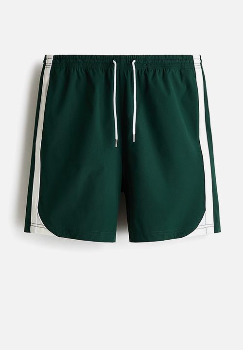 H&M - Regular fit track shorts - dark green/colour block