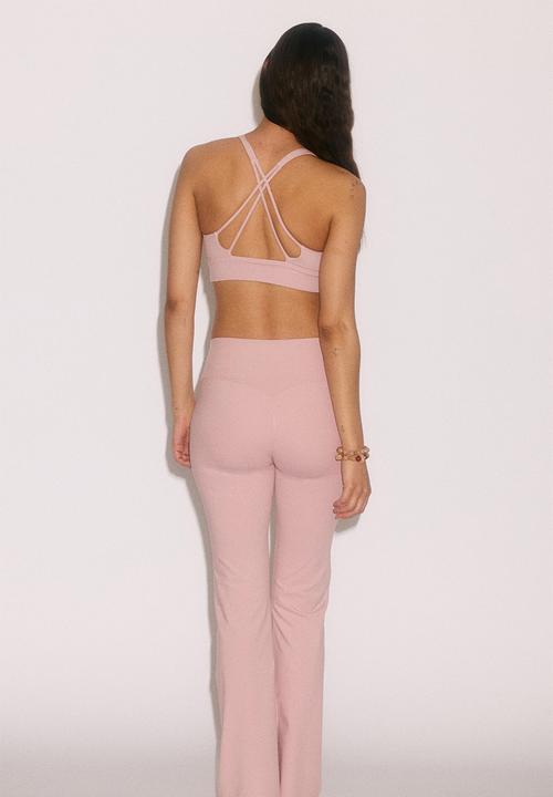 H&M - Flared yoga leggings with softmove. - pastel pink