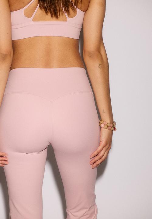 H&M - Flared yoga leggings with softmove. - pastel pink