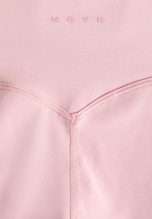 H&M - Flared yoga leggings with softmove. - pastel pink