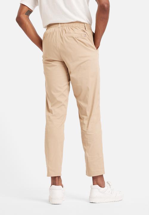 New Balance  - NB Athletics Tapered Pant - Brown