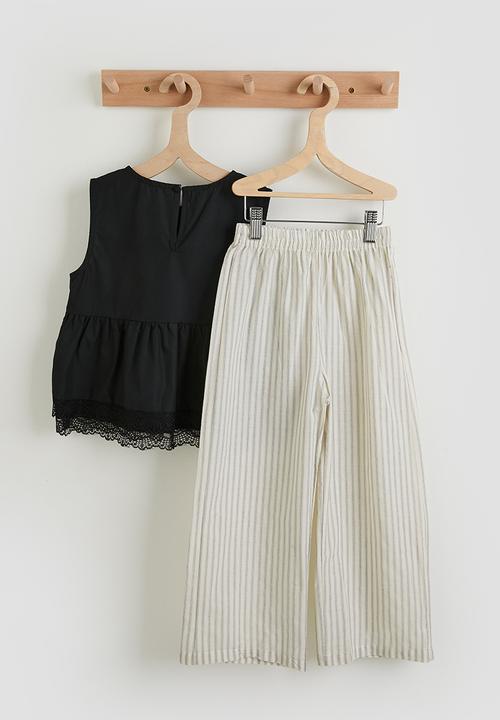 Pop Candy - Lace hem peplum top with striped pants - black/ivory