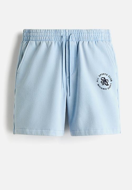 H&M - Relaxed fit shorts - light blue/all sports club