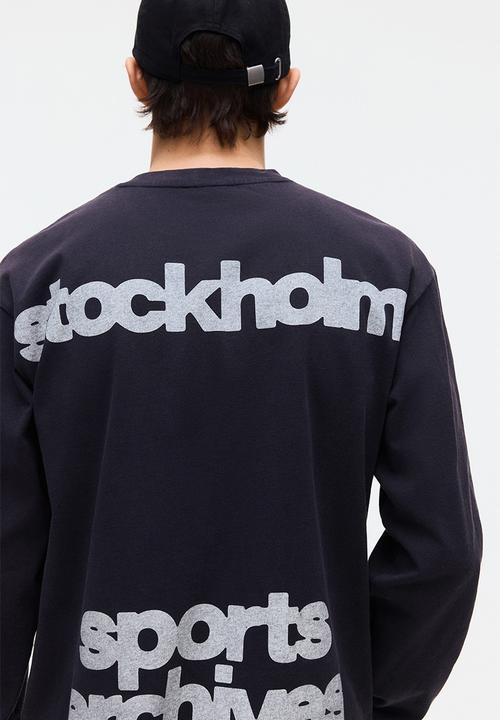 H&M - Loose fit printed long-sleeved top - navy blue/sports archives