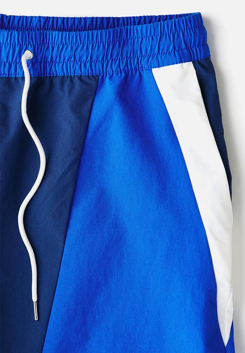 H&M - Loose fit track shorts - dark blue/colour block