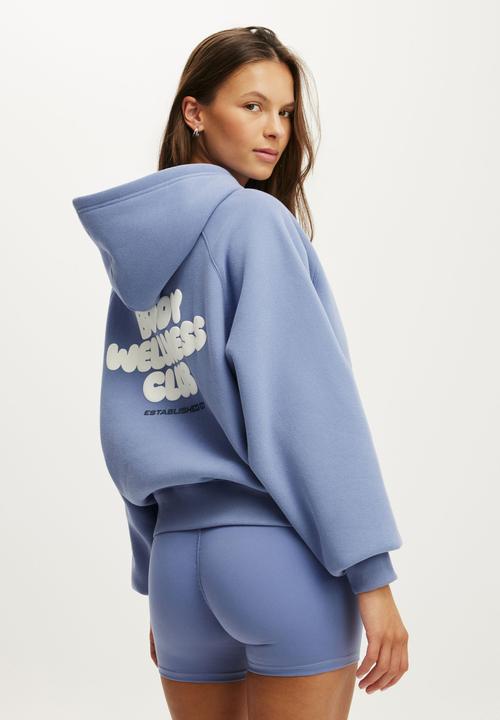 Cotton On - Plush Premium Graphic Raglan Hoodie - Blue Ice/Body Wellness