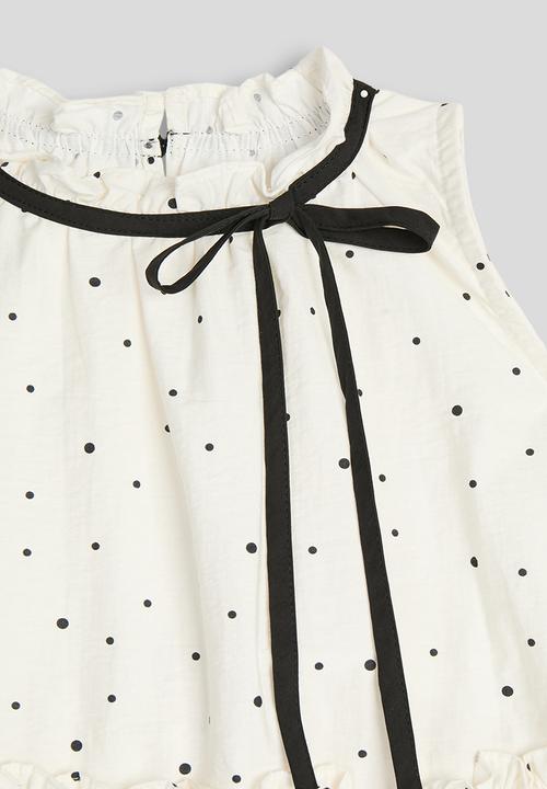 Pop Candy - Dotted pattern dropped hem top - cream