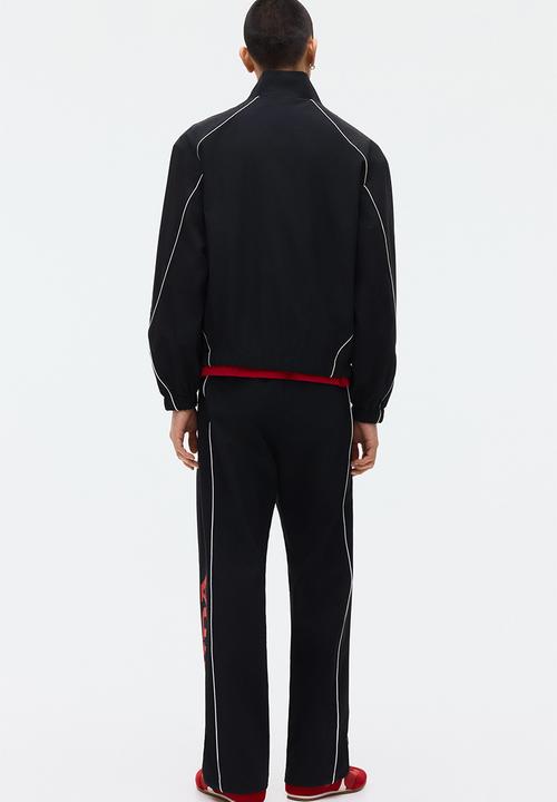 H&M - Relaxed fit printed track pants - black/honda