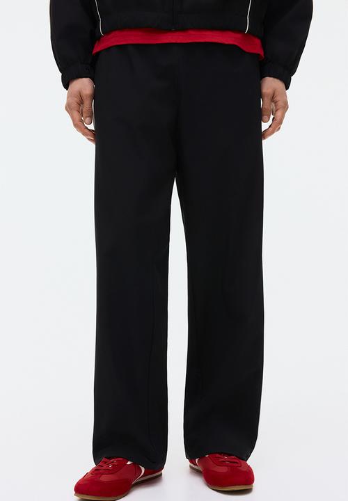 H&M - Relaxed fit printed track pants - black/honda