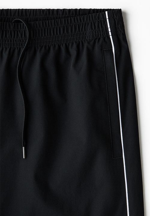 H&M - Relaxed fit printed track pants - black/honda