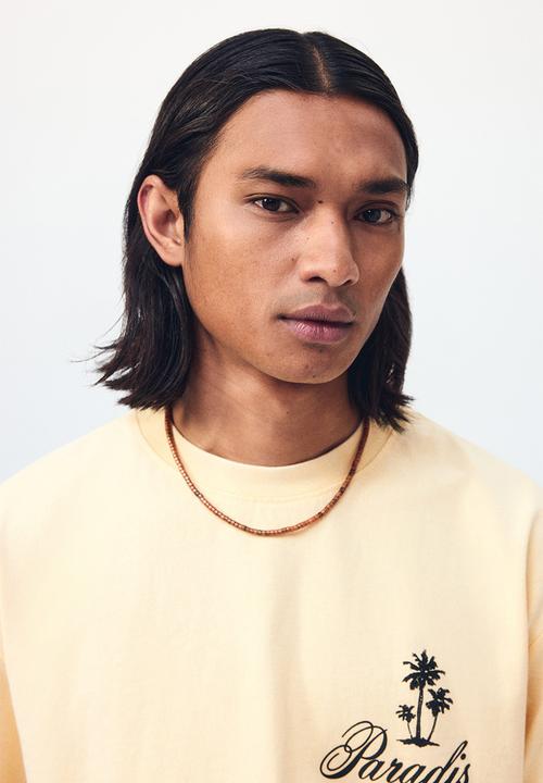 H&M - Relaxed fit printed cotton T-shirt - light yellow/paradis