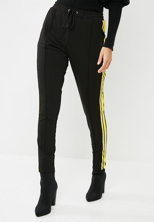 black joggers with yellow side stripe