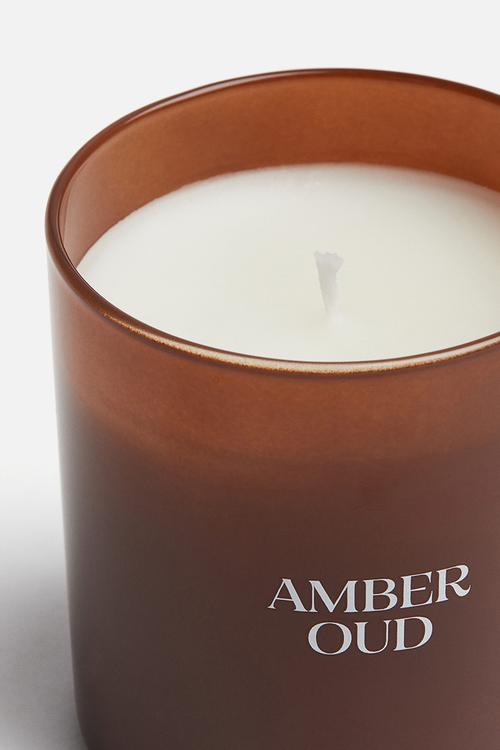 Scented candle in a glass holder - amber oud