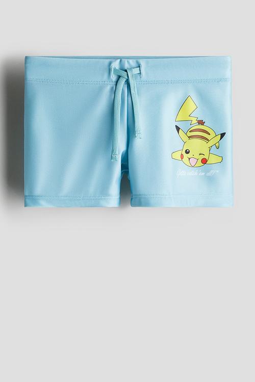 Printed swimming trunks - light blue/pokémon