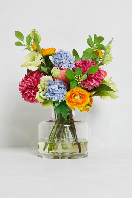 Mixed bunch brights in small jar vase