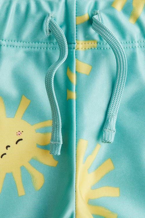 Printed swimming trunks - turquoise suns 