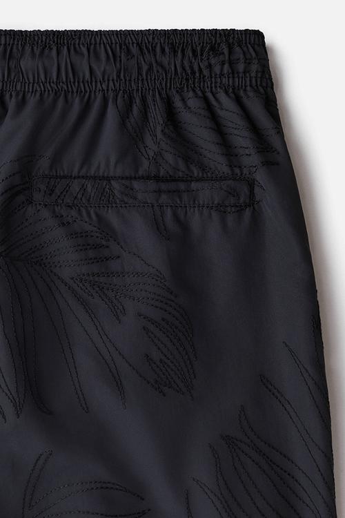 Patterned swim shorts - black leaf-patterned