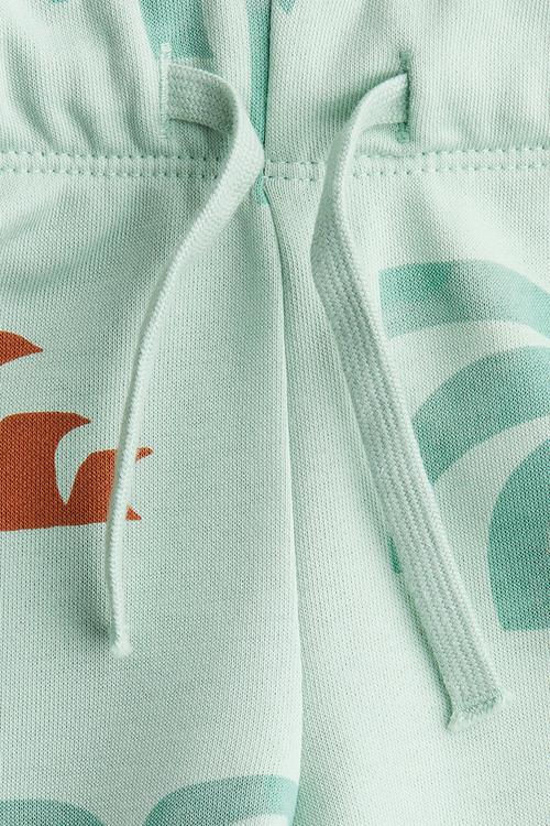 Printed sweatshorts - light turquoise/palm trees 