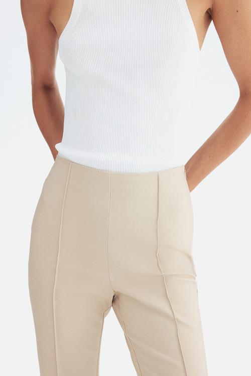 Flared crease-front trousers - light beige