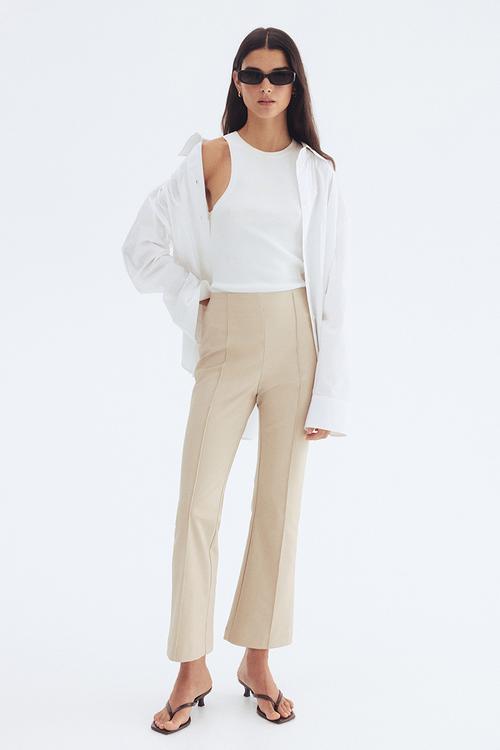 Flared crease-front trousers - light beige