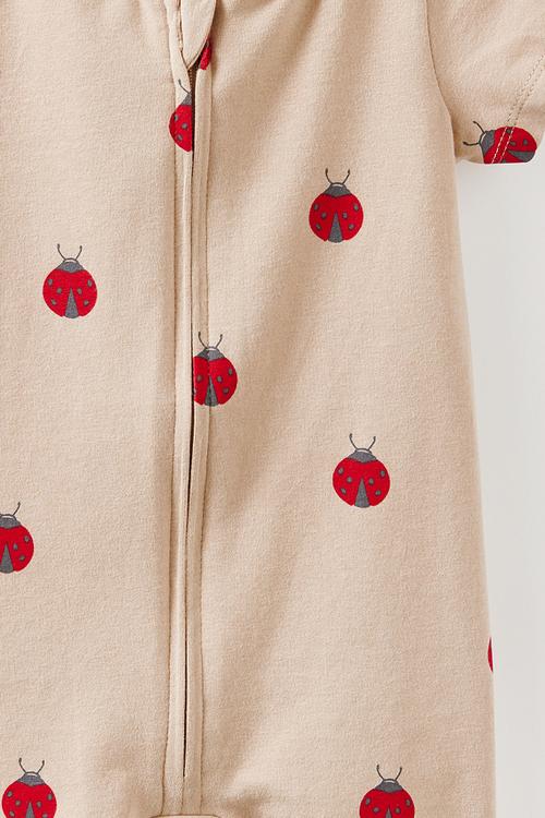 The Short Sleeve Zip Romper -  Latte Cream/Lady Bug
