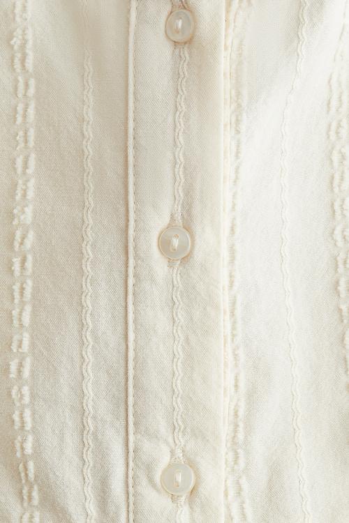 Sleeveless flounced blouse - light beige