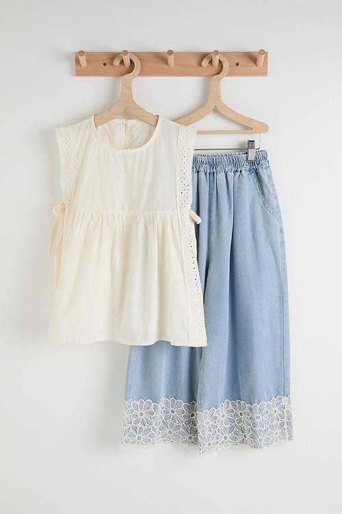 Flared apron-style top with floral applique jeans - cream/blue