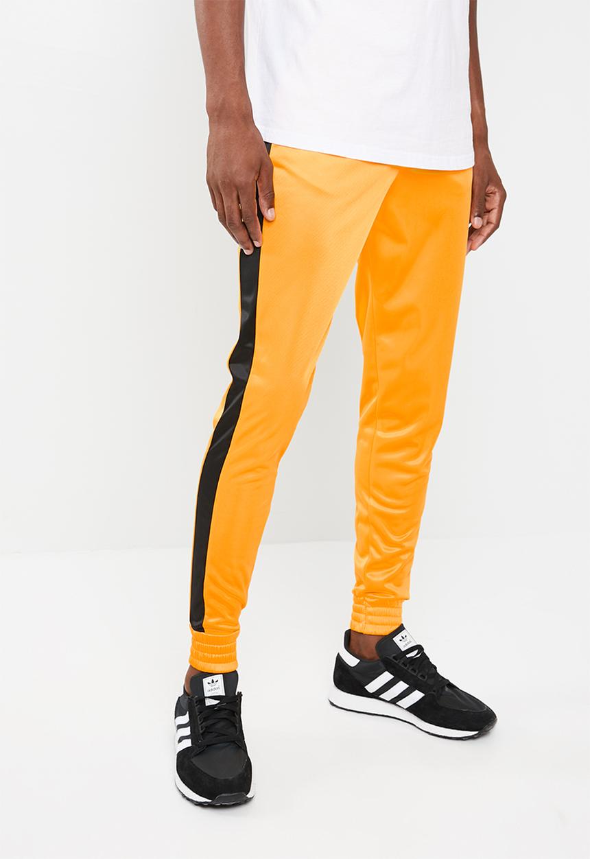 Superbalist - Slim side stripe tricot pant - orange and black