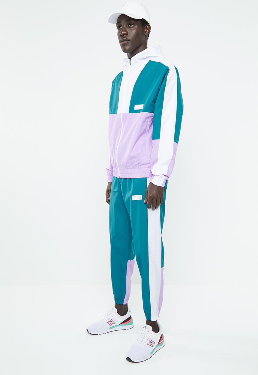 New Balance  - NB athletics windbreaker pant - green & white