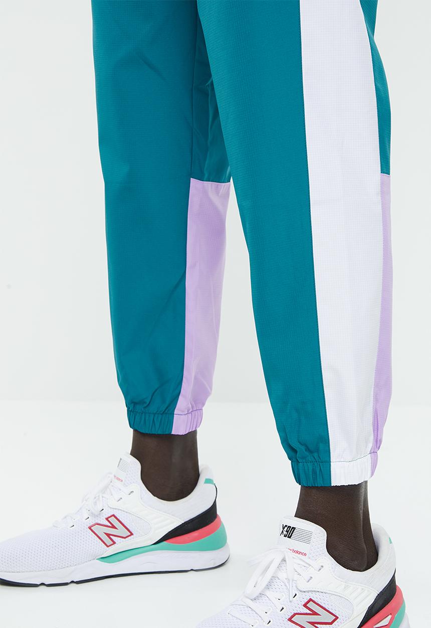 New Balance  - NB athletics windbreaker pant - green & white