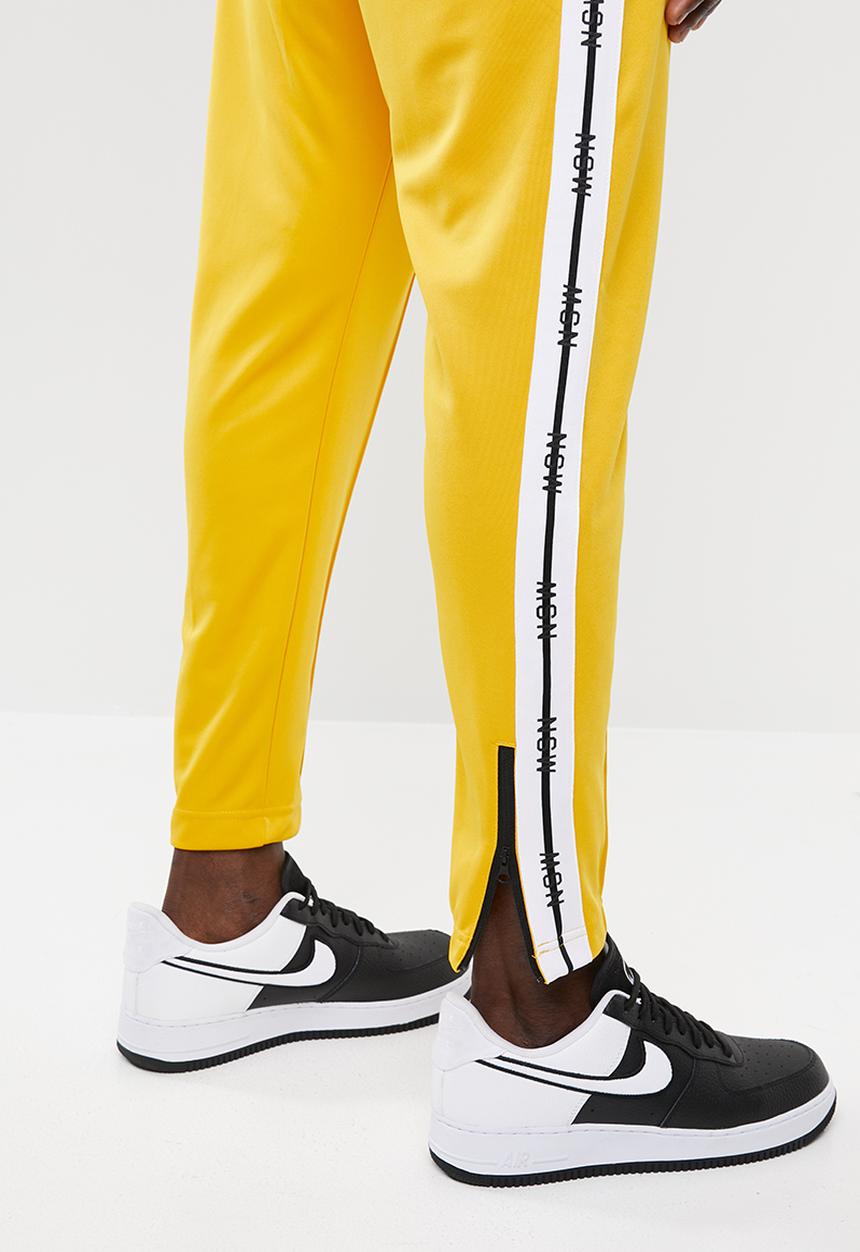Nike - M nsw nsp track pant - yellow 