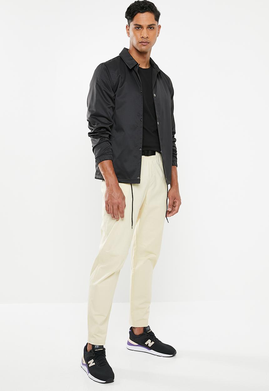 New Balance  - New Balance  athletics woven pant - beige 