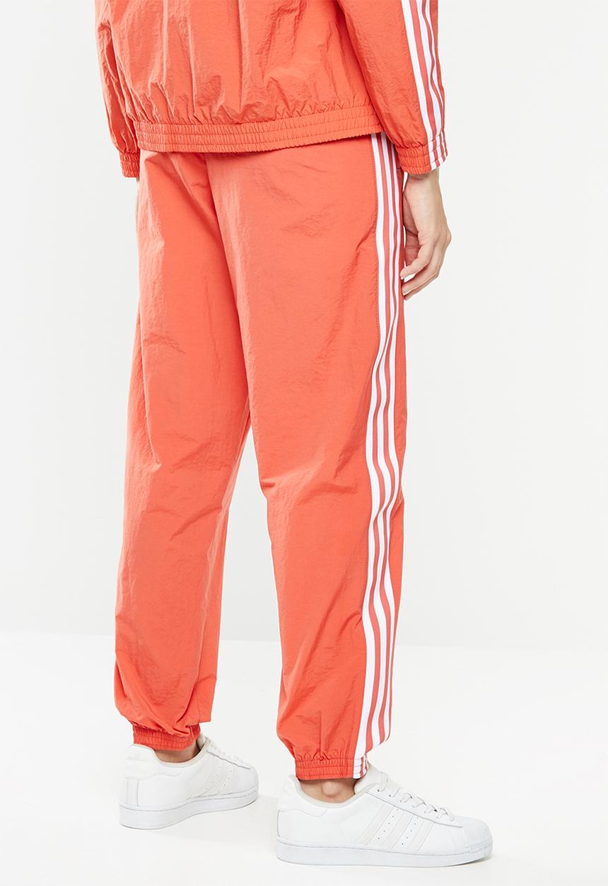 adidas Originals - Adicolour lock up track pants - orange & white