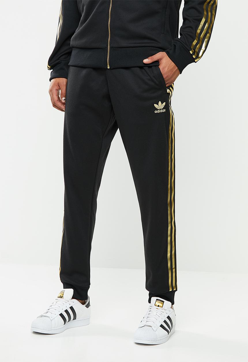 adidas Originals - SST50 track pants 24k - black & gold