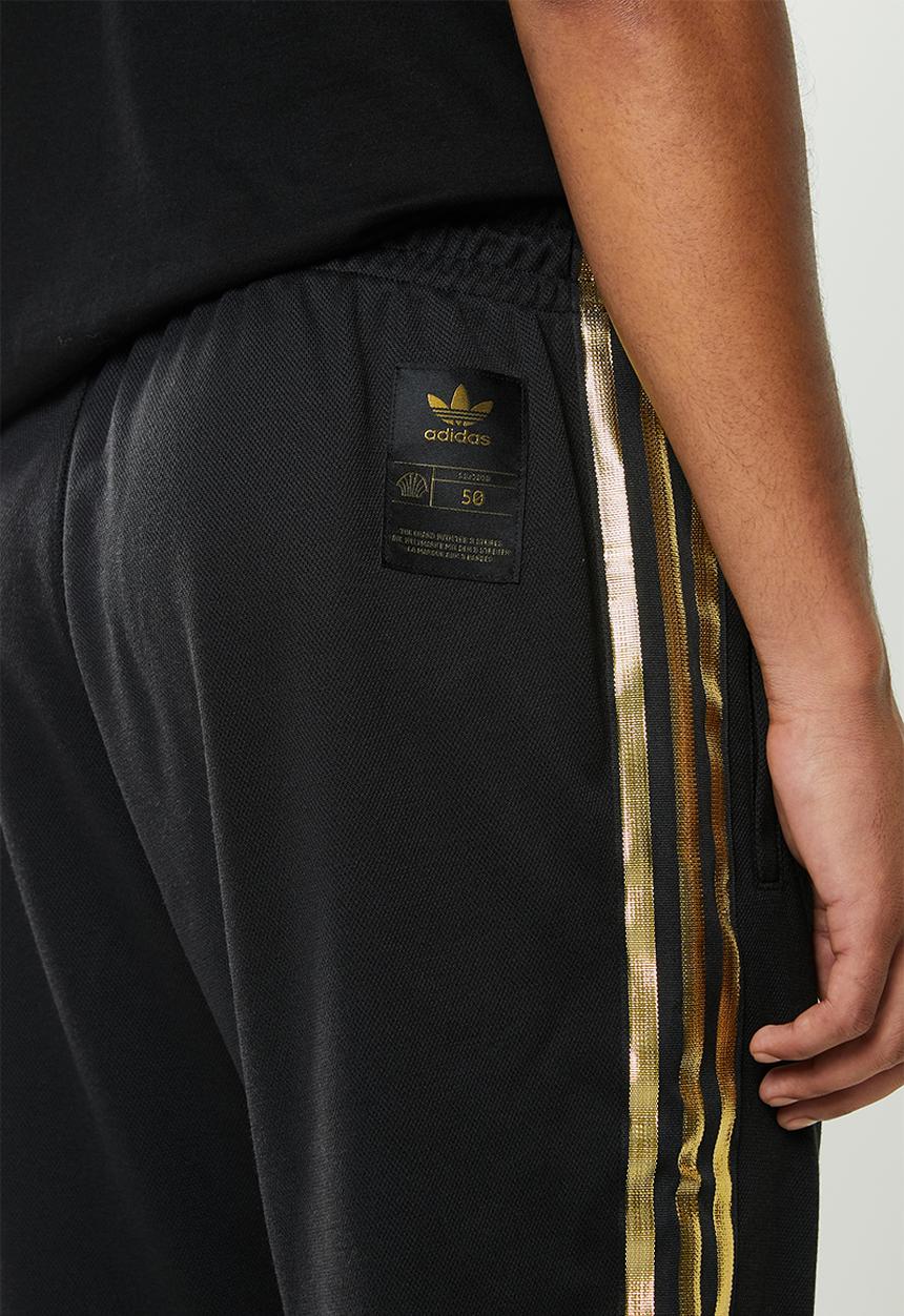 adidas Originals - SST50 track pants 24k - black & gold