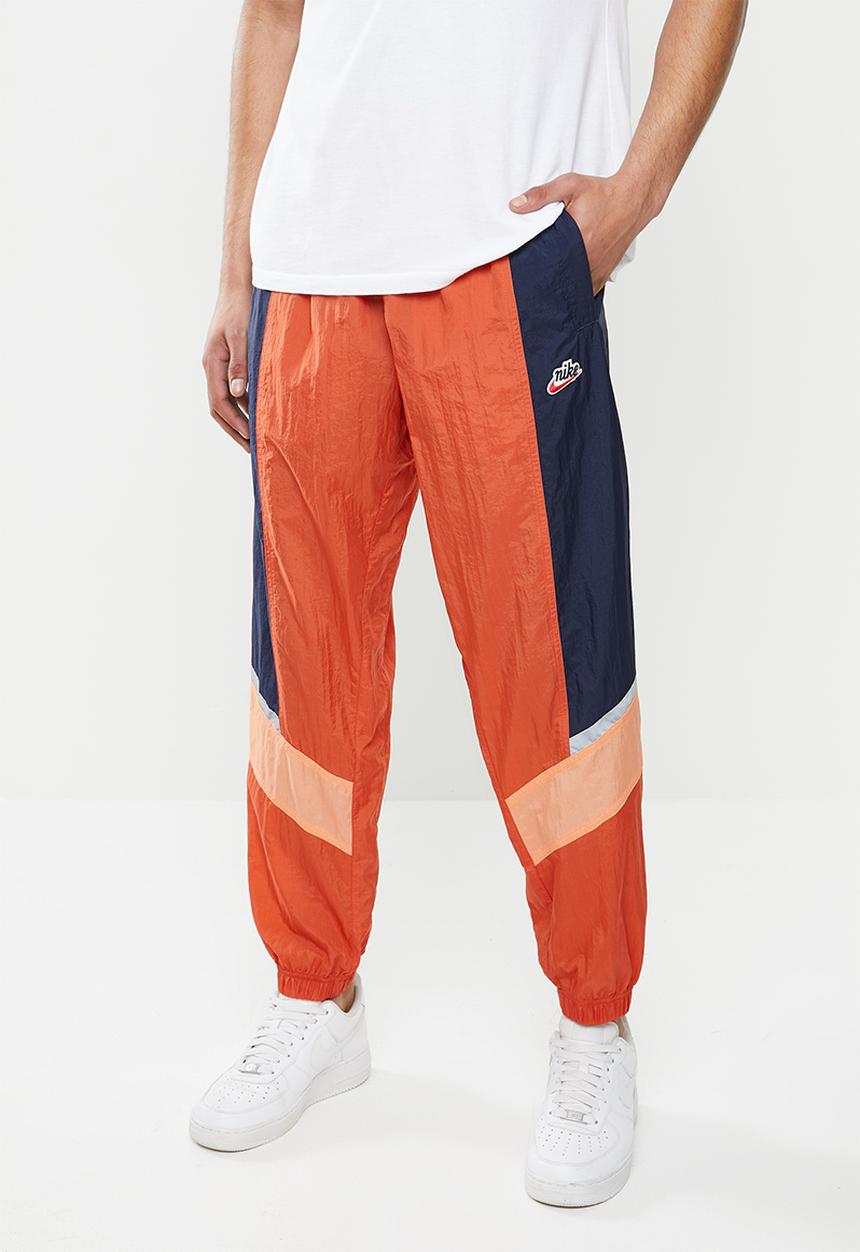 Nike - Nike sportswear he wr+ unld woven pants - orange & navy