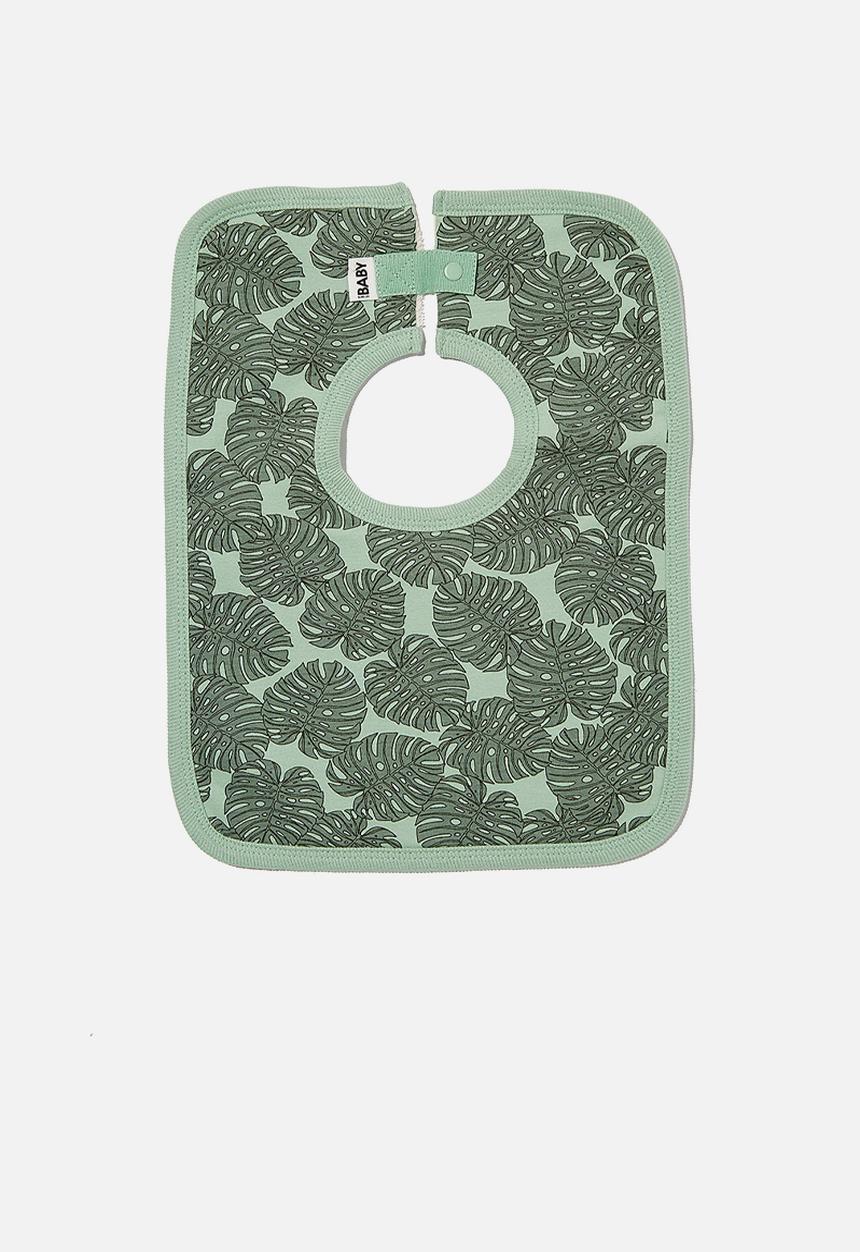 Cotton On - The square bib - smashed avo/tropical leaves