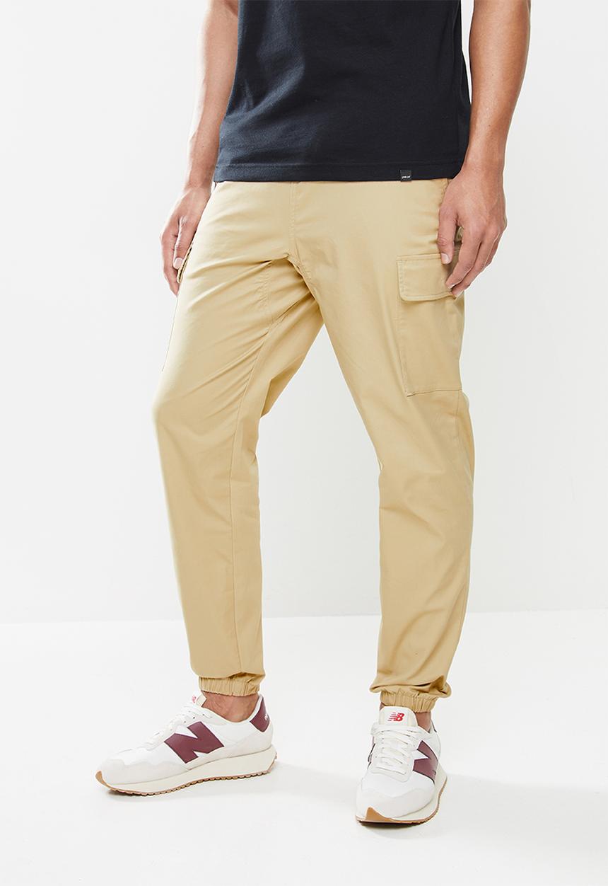 New Balance  - Nb athletics higher learning woven cargo pant - incense