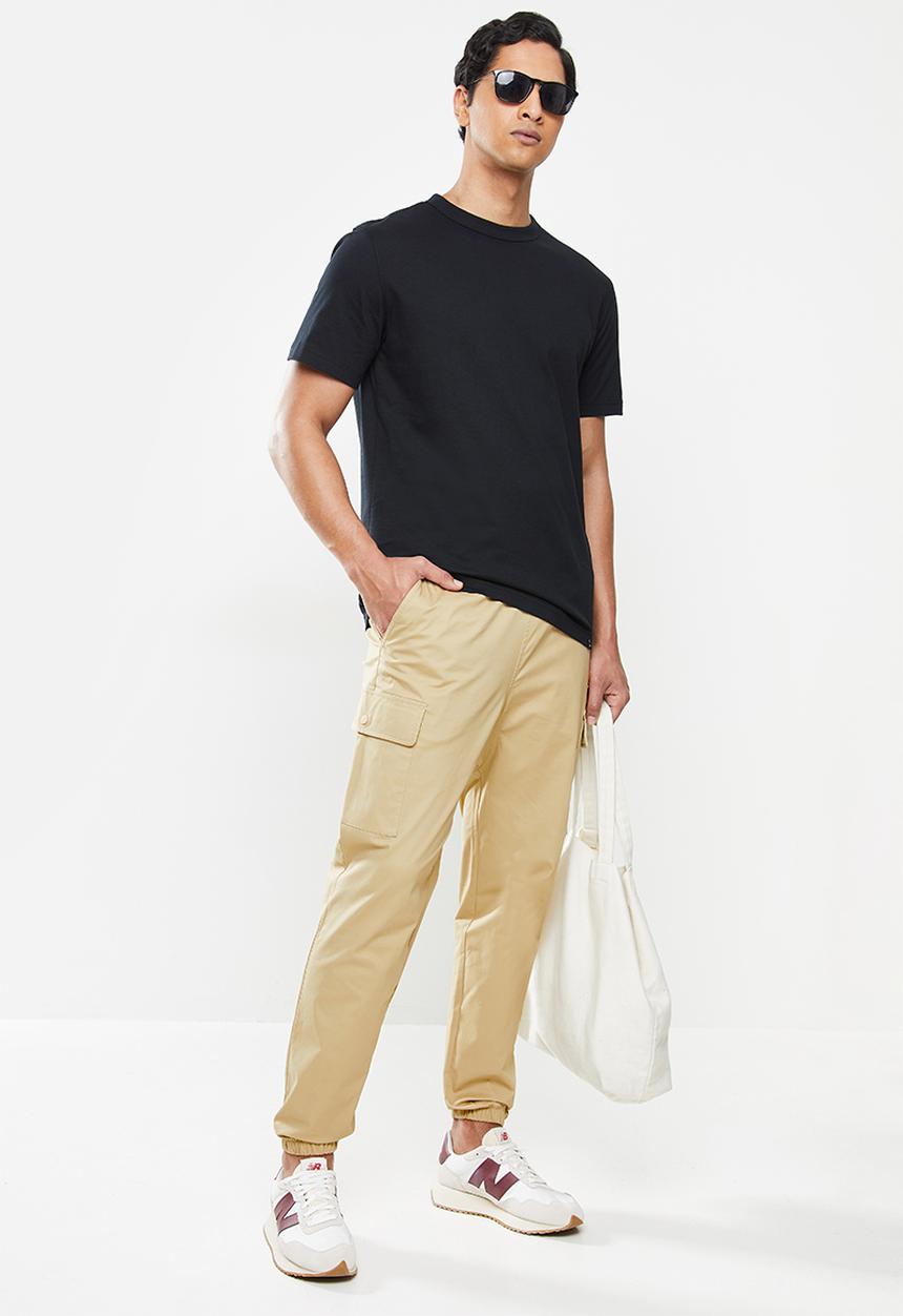 New Balance  - Nb athletics higher learning woven cargo pant - incense