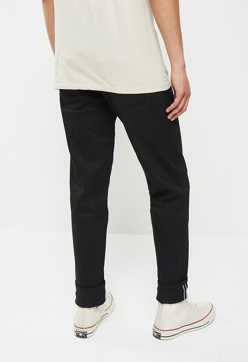 THE UNBRANDED BRAND - Relaxed tapered fit 11 oz solid black stretch selvedge denim